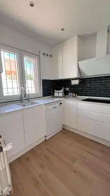 a kitchen with white cabinets and a sink at Adosado Dulce Barrosa in Chiclana de la Frontera