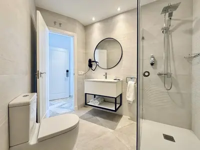 a bathroom with a toilet and a sink and a shower at Hotel Apartamentos Marina Luz in Chipiona