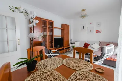 a living room with a table and chairs at Apartamentos Las Huertas in Cádiz