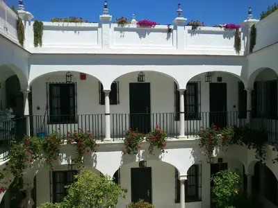 an apartment building with flower boxes on the balconies at Los Helechos in Sanlúcar de Barrameda