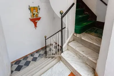a set of stairs in a building with a green handrail at La Herencia del REGIDOR by Cadiz4Rentals in Cádiz