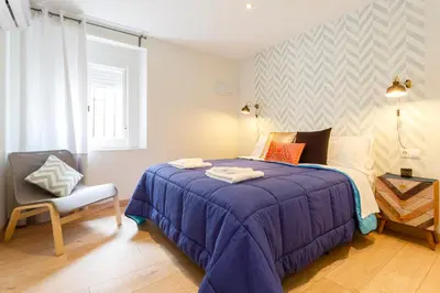 a bedroom with a purple bed and a chair at La Herencia del REGIDOR by Cadiz4Rentals in Cádiz
