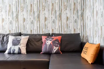 a brown leather couch with pillows on it at La Herencia del REGIDOR by Cadiz4Rentals in Cádiz