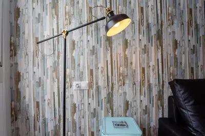 a lamp in a living room next to a couch at La Herencia del REGIDOR by Cadiz4Rentals in Cádiz