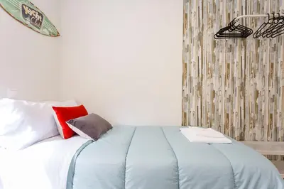 a bedroom with a bed with blue sheets and red pillows at La Herencia del REGIDOR by Cadiz4Rentals in Cádiz