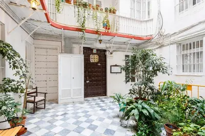 a balcony with plants and a wooden door at La Herencia del REGIDOR by Cadiz4Rentals in Cádiz