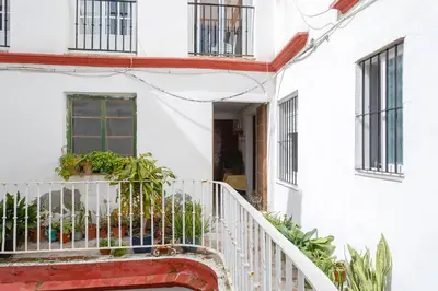 a white house with a staircase and plants at La Herencia del REGIDOR by Cadiz4Rentals in Cádiz
