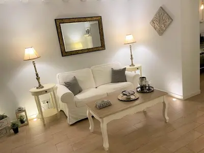 a living room with a white couch and a coffee table at No 14 Cádiz in Cádiz