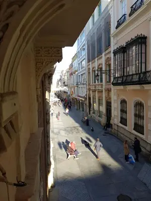 a group of people walking down a city street at No 14 Cádiz in Cádiz