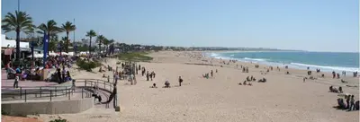 a large group of people on a beach at Chalet en Hozanejos RS in Chiclana de la Frontera