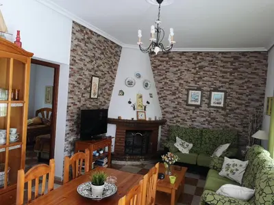 a living room with a couch and a fireplace at Chalet en Hozanejos RS in Chiclana de la Frontera