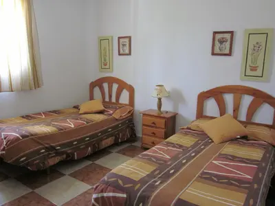 two beds sitting next to each other in a bedroom at Chalet en Hozanejos RS in Chiclana de la Frontera