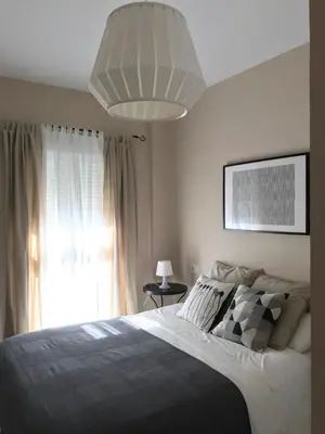 a bedroom with a large bed and a large window at Apartamento Costa Ballena in Rota