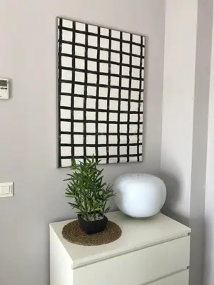 a plant on top of a white cabinet with a window at Apartamento Costa Ballena in Rota