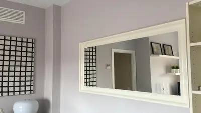 a mirror on a wall in a bathroom at Apartamento Costa Ballena in Rota