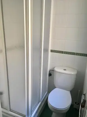 a bathroom with a toilet and a shower at Apartamento Costa Ballena in Rota