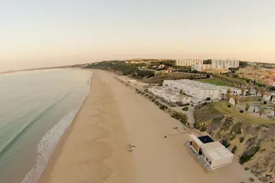 an aerial view of a beach with buildings and the ocean at Apartamentos Bahía Blanca in El Puerto de Santa María