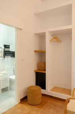 a room with a white wall with a shelf at Rompeolas Playa in Chipiona