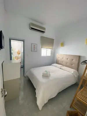 a bedroom with a large white bed in a room at Hostal Avenida by Bossh! Hotels in Chipiona