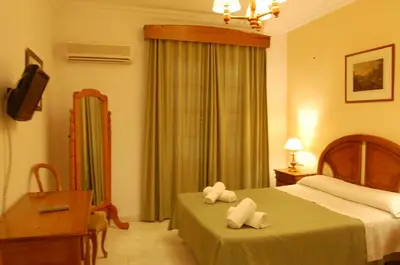 a hotel room with a bed with towels on it at Hotel Antonio Conil in Conil de la Frontera