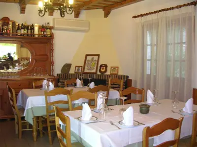 a restaurant with white tables and chairs and a mirror at Hotel Antonio Conil in Conil de la Frontera