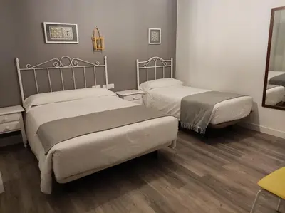 a room with a desk with a television on it at Hostal Andalucía in Chipiona