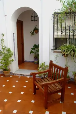 a spiral staircase with a plant in a pot at Hostal Andalucía in Chipiona