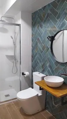 a bathroom with a sink and a shower at Hostal Andalucía in Chipiona