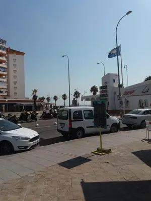 a parking lot with a lot of cars and motorcycles at La casa De Los Faros in El Puerto de Santa María