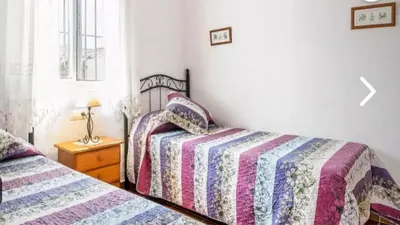 a bedroom with two beds and a window at Casa Colada 3 in Conil de la Frontera