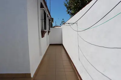 a hallway with a white wall and a tile floor at Casa Colada 3 in Conil de la Frontera