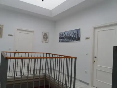 a white bedroom with a bed and a table at Big House Jerez in Jerez de la Frontera