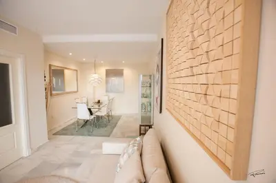 a living room with a stone wall and a couch at Casa Manzanilla in Sanlúcar de Barrameda
