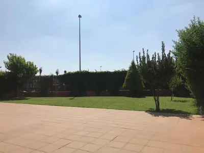 a flag pole in the middle of a park at Casa Manzanilla in Sanlúcar de Barrameda