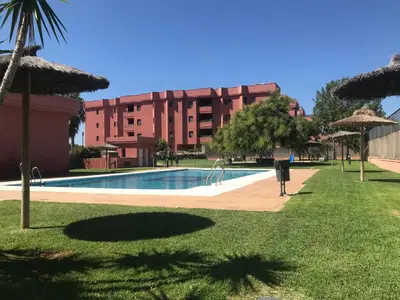 a swimming pool in front of a building at Casa Manzanilla in Sanlúcar de Barrameda