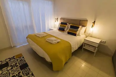 a bedroom with a large bed with towels on it at SH Rosario. Loft chic en el centro histórico in Cádiz