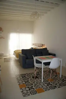 a living room with a blue couch and a table at SH Rosario. Loft chic en el centro histórico in Cádiz