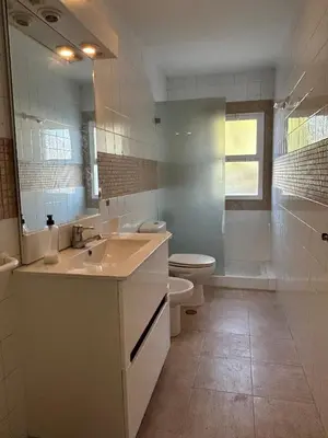 a bathroom with a sink and a toilet and a mirror at Chalet a 100m de la playa en El Puerto in El Puerto de Santa María