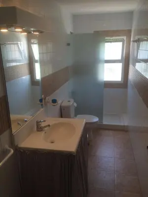 a bathroom with a sink and a toilet and a mirror at Chalet a 100m de la playa en El Puerto in El Puerto de Santa María