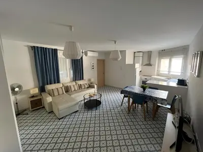 a living room with a couch and a table at El Rincón de la Playa SantaMaría Grupo AC Gestion in Cádiz