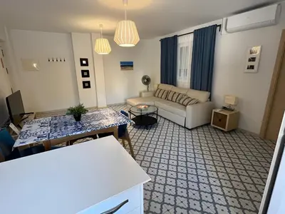 a living room with a couch and a table at El Rincón de la Playa SantaMaría Grupo AC Gestion in Cádiz