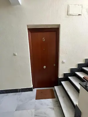 an empty room with a brown door in a building at El Rincón de la Playa SantaMaría Grupo AC Gestion in Cádiz