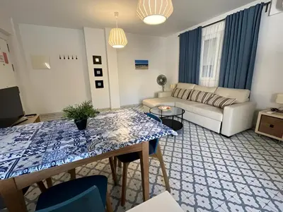 a living room with a couch and a table at El Rincón de la Playa SantaMaría Grupo AC Gestion in Cádiz
