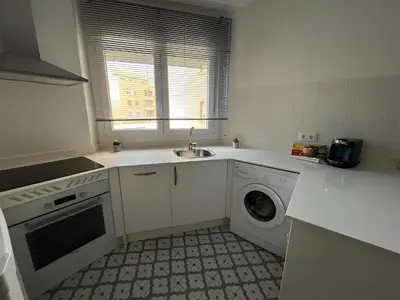 a kitchen with a sink and a washing machine at El Rincón de la Playa SantaMaría Grupo AC Gestion in Cádiz