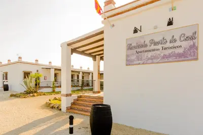 a building with a sign on the side of it at Hacienda Puerto Conil in Conil de la Frontera