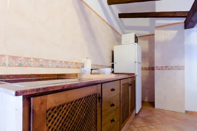 a kitchen with a sink and a refrigerator at Hacienda Puerto Conil in Conil de la Frontera