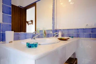 a bathroom with a white sink and a mirror at Hacienda Puerto Conil in Conil de la Frontera