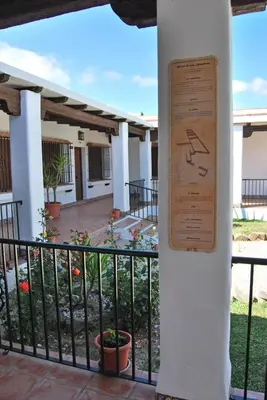 a sign on a column in front of a building at Hacienda Puerto Conil in Conil de la Frontera