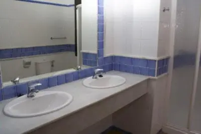 a bathroom with two sinks and a mirror at Hacienda Puerto Conil in Conil de la Frontera