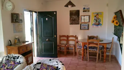 a kitchen with a table and a dining room at La Pavona 11 - 1ª línea de Playa Chipiona in Chipiona